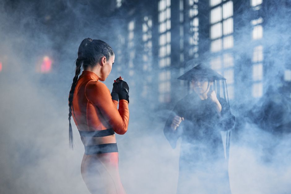 Two cosplayers in martial arts poses creating an intense and dramatic scene.