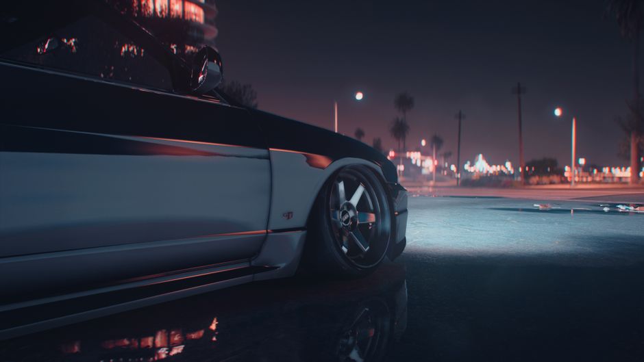 A stylish sports car captured at night in an urban environment with city lights.